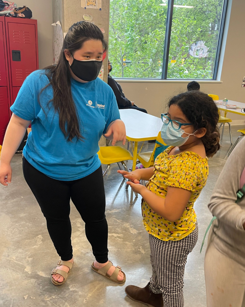 A woman talking to a student.