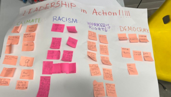 Leadership in action post with sticky notes detailing students' ideas for how they can be a leader in addressing areas like democracy, worker's rights, climate change, and racism