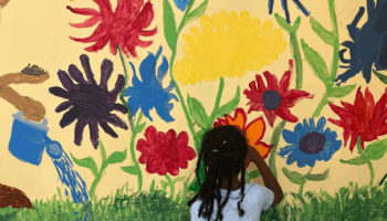 Student working on a mural