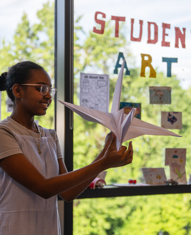A student holding a paper crane