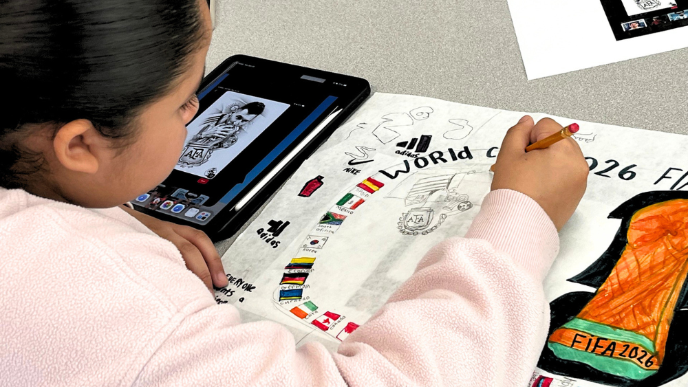 Photo of student coloring World Cup design