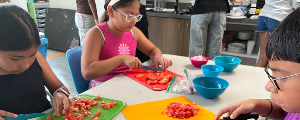 Students chopping tomatoes