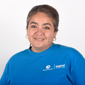 A woman in a blue Aspire AmeriCorps t-shirt