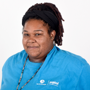Website Testimonial Headshots(1) A woman in a blue Aspire AmeriCorps t-shirt