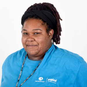 A woman in a blue Aspire AmeriCorps t-shirt