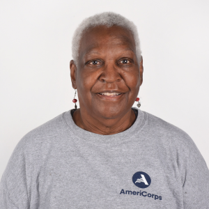 A woman in a gray AmeriCorps t-shirt