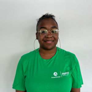 Website Testimonial Headshots(6) A woman in a green Aspire AmeriCorps t-shirt