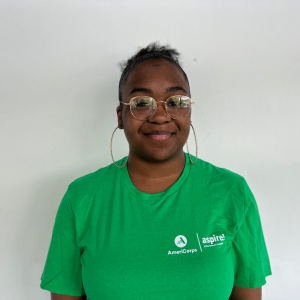 A woman in a green Aspire AmeriCorps t-shirt